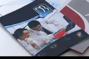 Open presentation folder with laboratory photograph and inside pocket