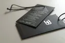 Black board hang tags with white print and black string