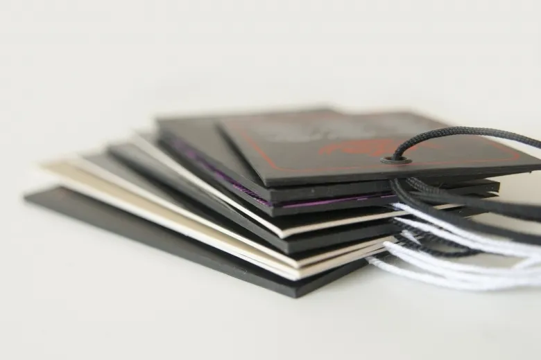Stack of board hang tags in several colours with strings