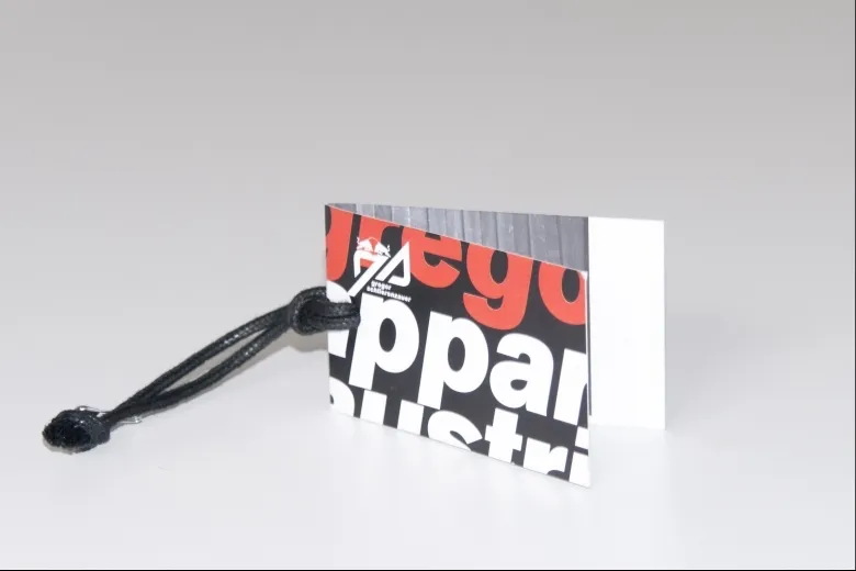 Folded hang tag printed with bold red and black graphics and string